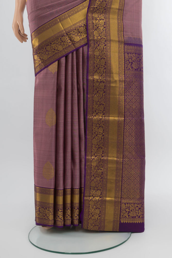 Pleats and pallu of Bronze Kanchipuram Silk Saree with Zari Butta on the body and Silk Border. 