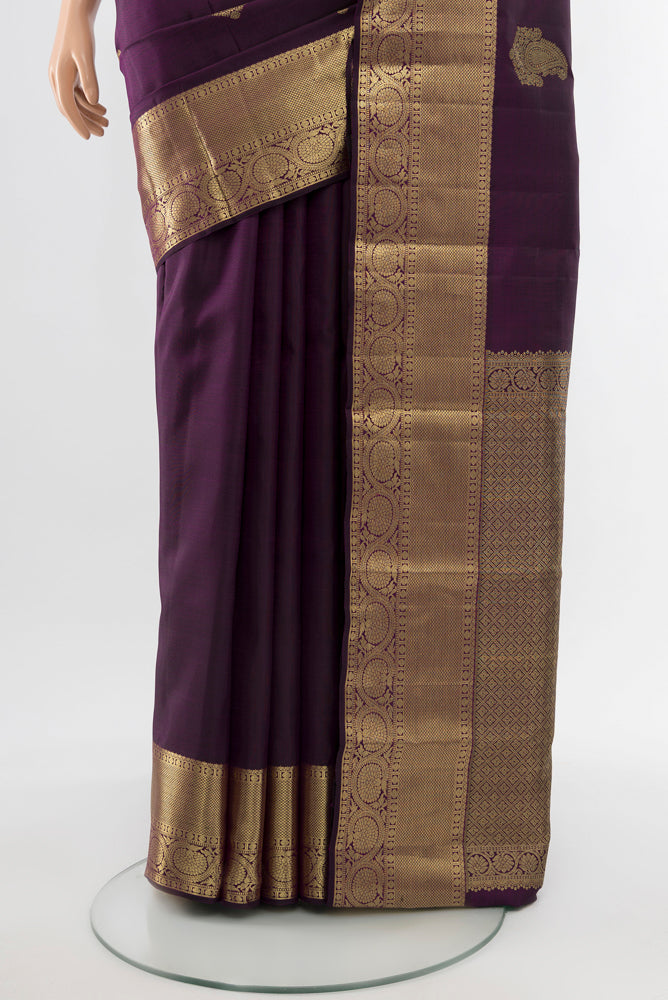 Pleats and pallu of Violet Kanchipuram Silk Saree with Zari Butta on the body and Silk Border. 