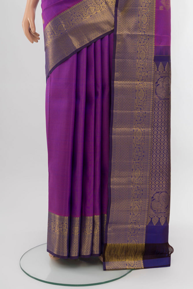 Pleats and pallu of Purple Kanchipuram Silk Saree with Zari Brocade on the body and Silk Border. 