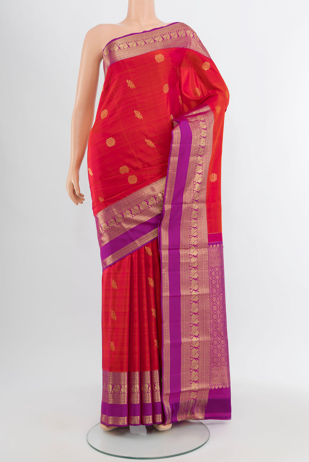 Peach Kanjivaram Silk Saree with Zari Butta on the body and Silk Border.  displayed on a mannequin