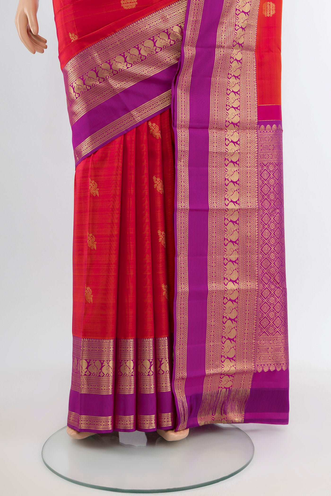Pleats and pallu of Peach Kanjivaram Silk Saree with Zari Butta on the body and Silk Border. 