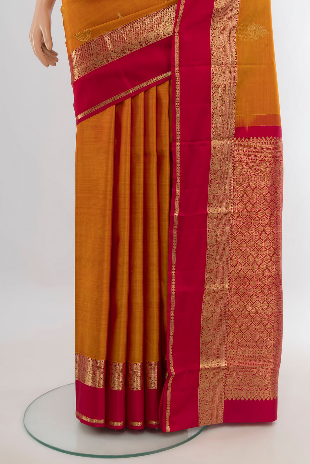 Pleats and pallu of Pure Silk Mustard Kanjivaram Saree with Zari Butta on the body and Zari Border. 