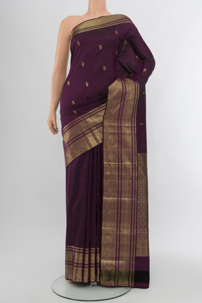 Violet Kanjivaram Silk Saree with Zari Butta on the body and Silk Border.  displayed on a mannequin
