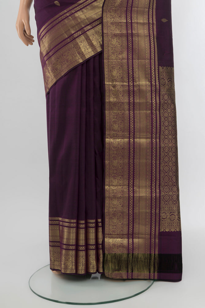 Pleats and pallu of Violet Kanjivaram Silk Saree with Zari Butta on the body and Silk Border. 
