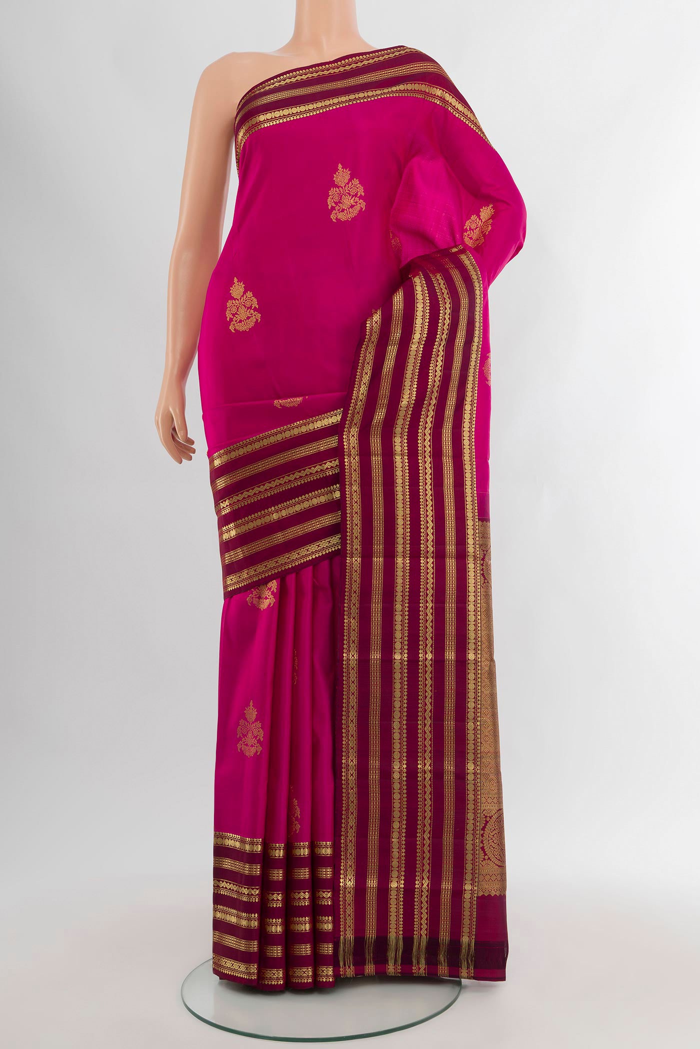 Dark Pink Kanjivaram Silk Saree with Zari Butta on the body and Zari Border.  displayed on a mannequin