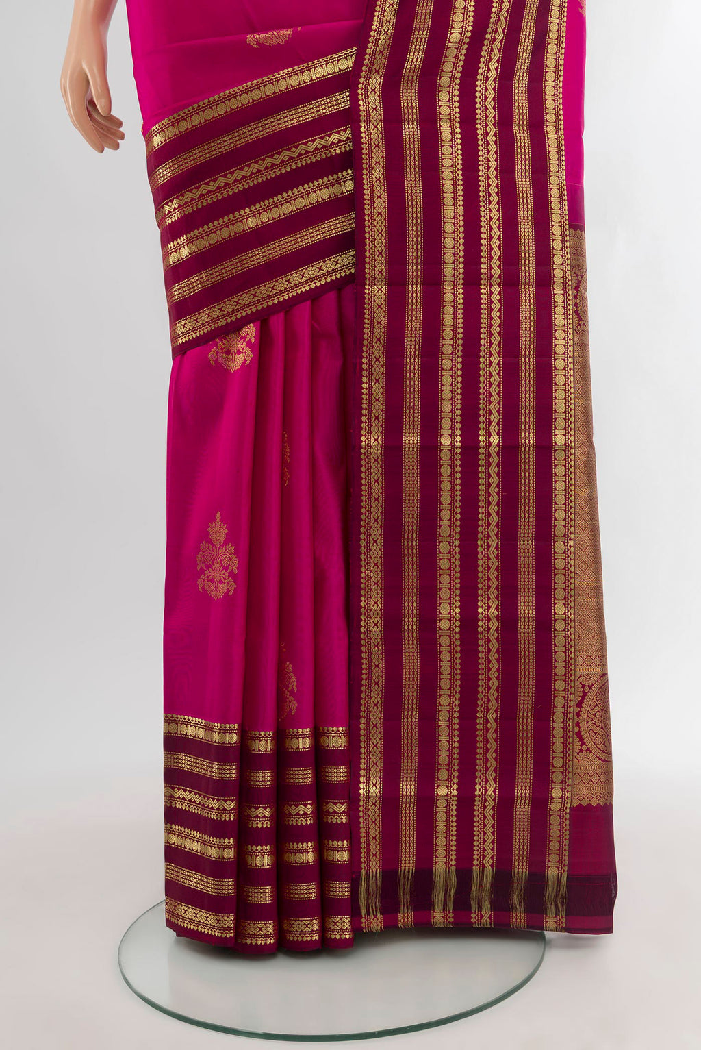 Pleats and pallu of Dark Pink Kanjivaram Silk Saree with Zari Butta on the body and Zari Border. 