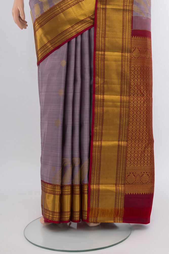 Pleats and pallu of Lavender Kanjivaram Silk Saree with Zari Butta on the body and Silk Border. 