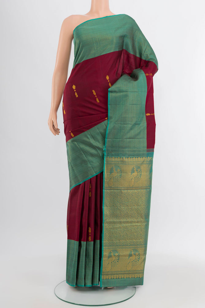 Coffee Brown Kanjivaram Silk Saree with Zari Butta on the body and Silk Border.  displayed on a mannequin