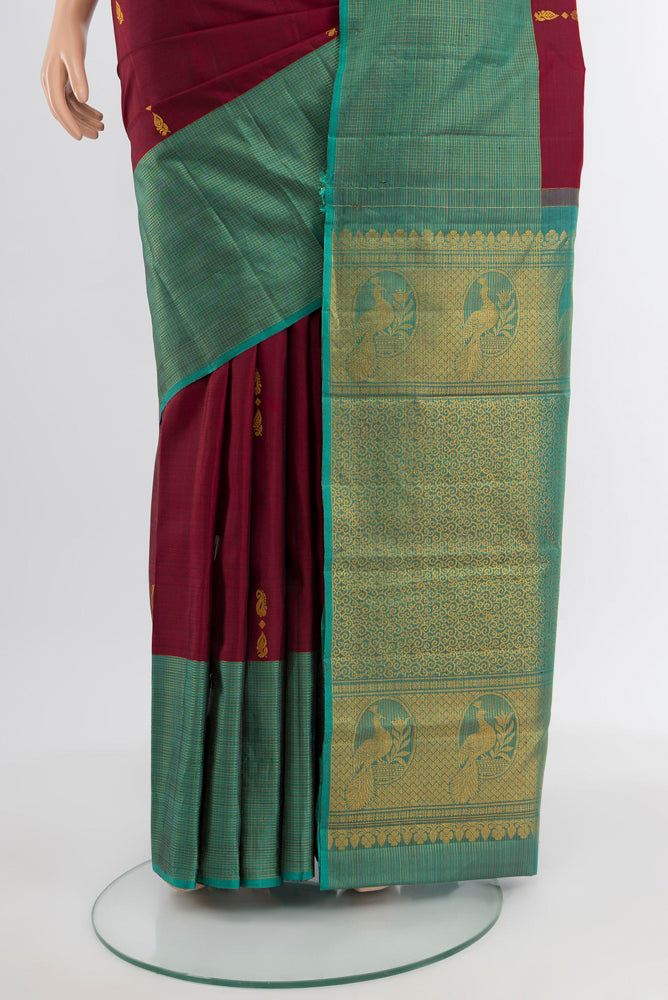 Pleats and pallu of Coffee Brown Kanjivaram Silk Saree with Zari Butta on the body and Silk Border. 