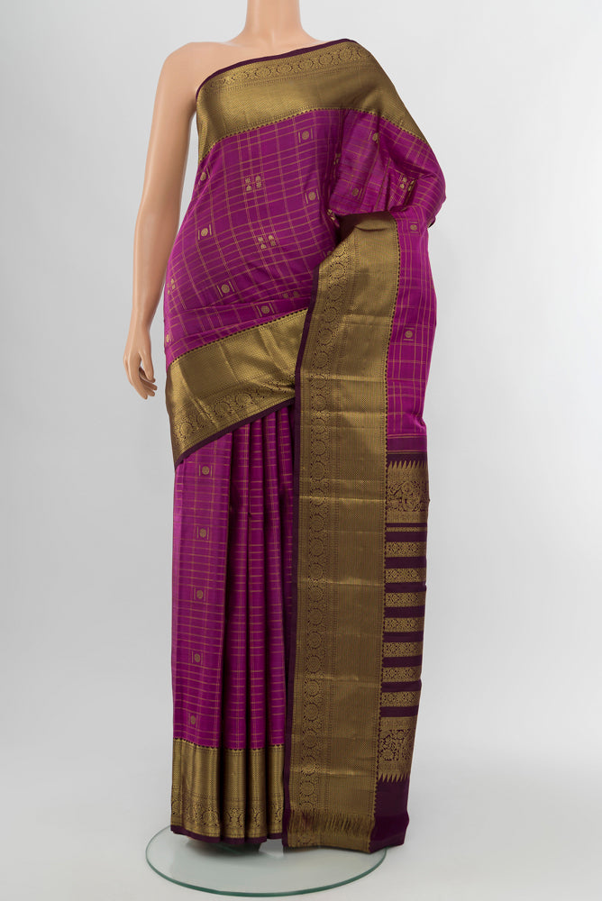 Purple Kanjivaram Silk Saree with Zari Butta on the body and Silk Border.  displayed on a mannequin