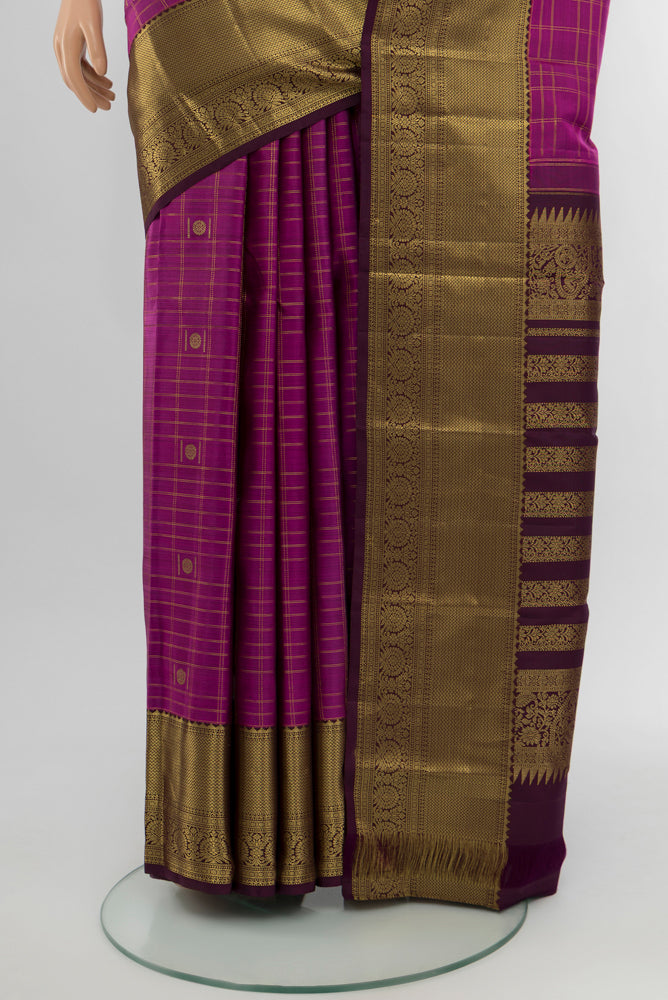 Pleats and pallu of Purple Kanjivaram Silk Saree with Zari Butta on the body and Silk Border. 