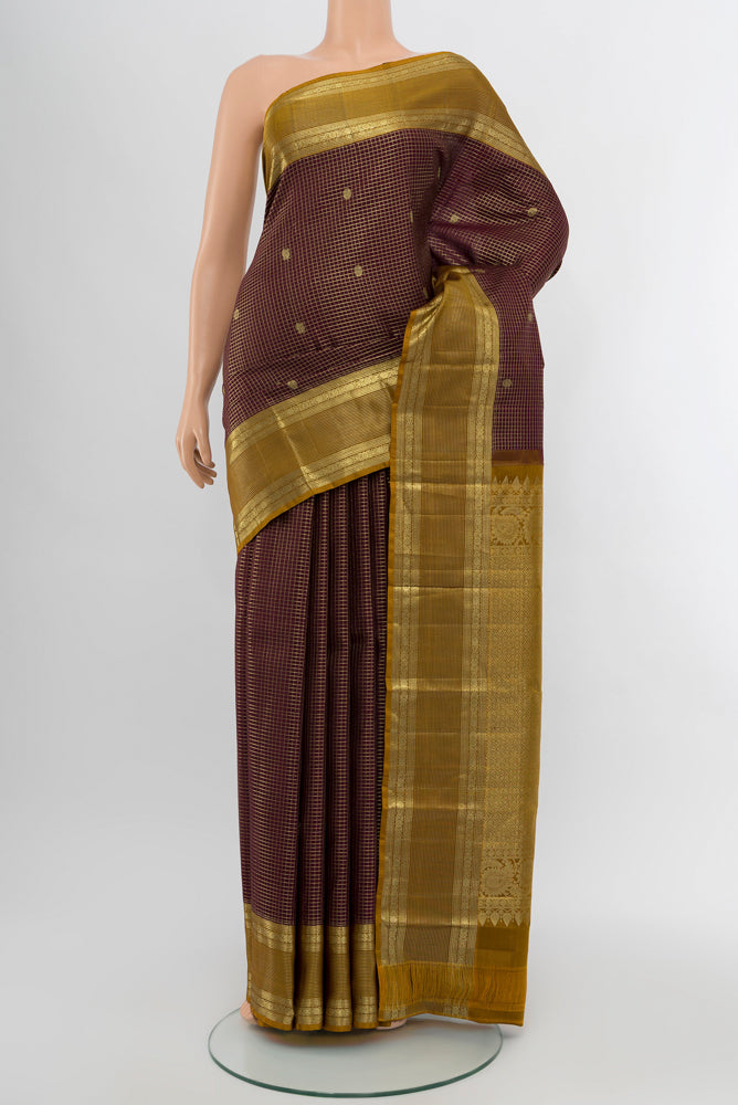 Coffee Brown Kanjivaram Silk Saree with Zari Butta on the body and Silk Border.  displayed on a mannequin