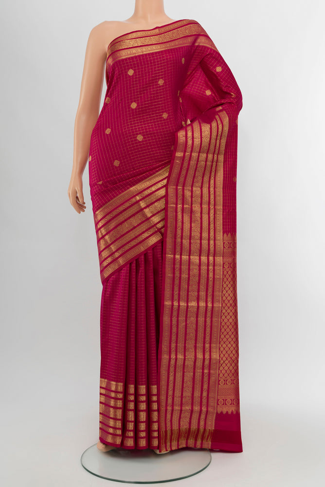 Dark Pink Kanjivaram Silk Saree with Zari Butta on the body and Silk Border.  displayed on a mannequin