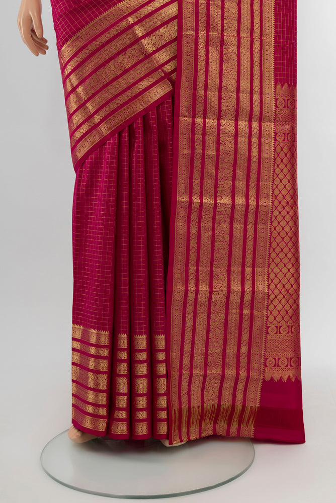 Pleats and pallu of Dark Pink Kanjivaram Silk Saree with Zari Butta on the body and Silk Border. 