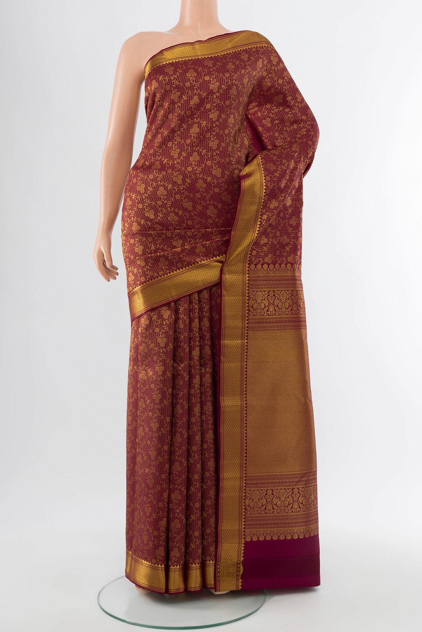 Coffee Brown Kanchipuram Silk Saree with Zari Butta on the body and Silk Border.  displayed on a mannequin