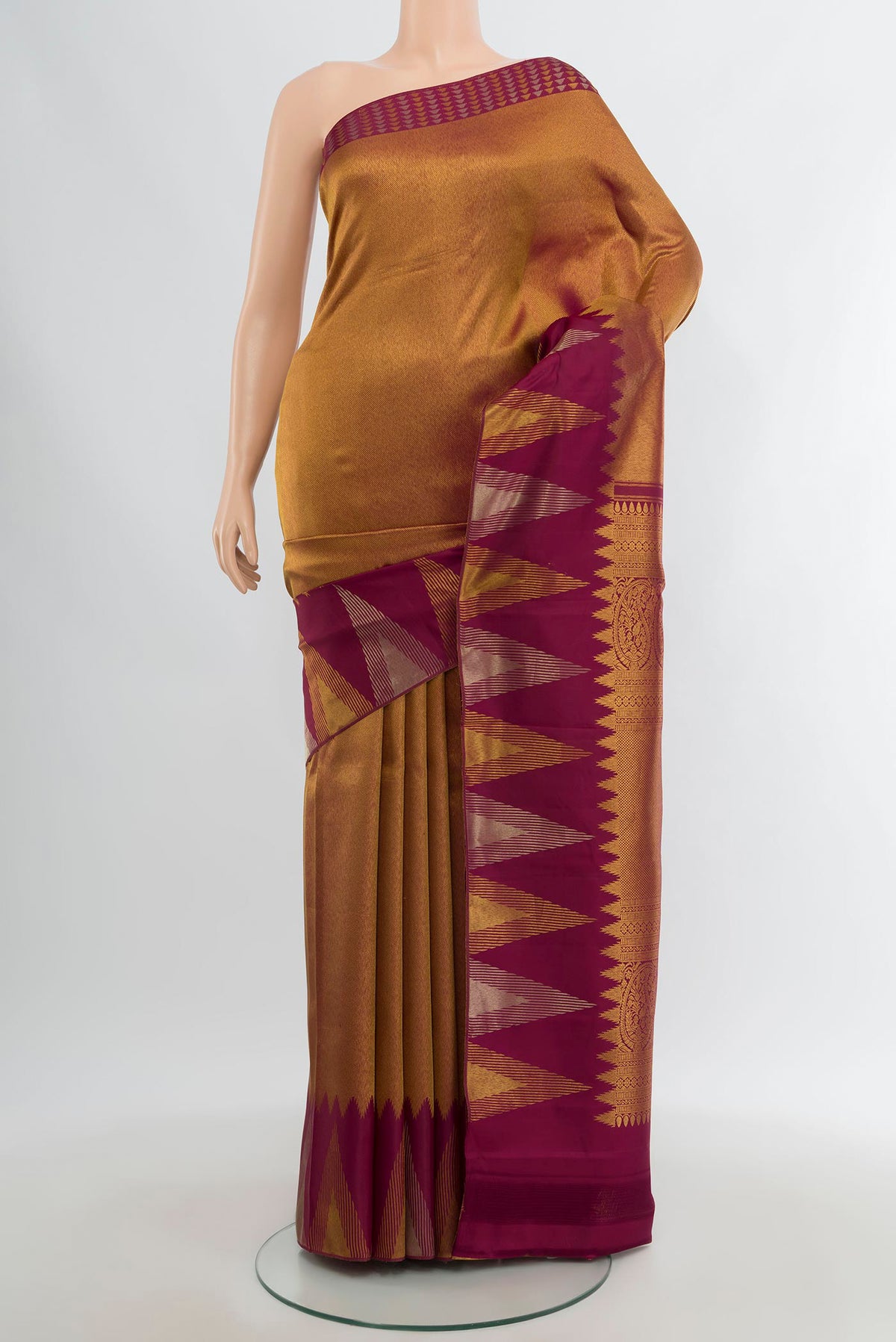 Golden Kanjivaram Silk Saree with Zari Brocade on the body and Temple Border.  displayed on a mannequin