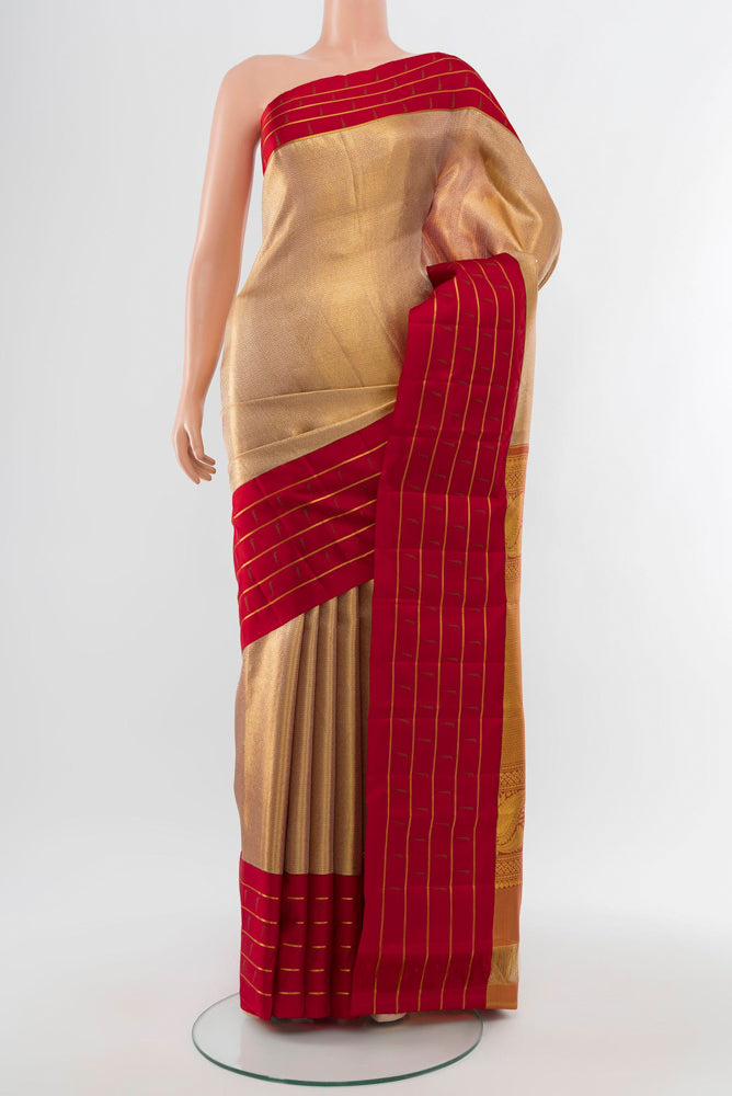 Golden Kanjivaram Silk Saree with Zari Butta on the body and Silk Border.  displayed on a mannequin