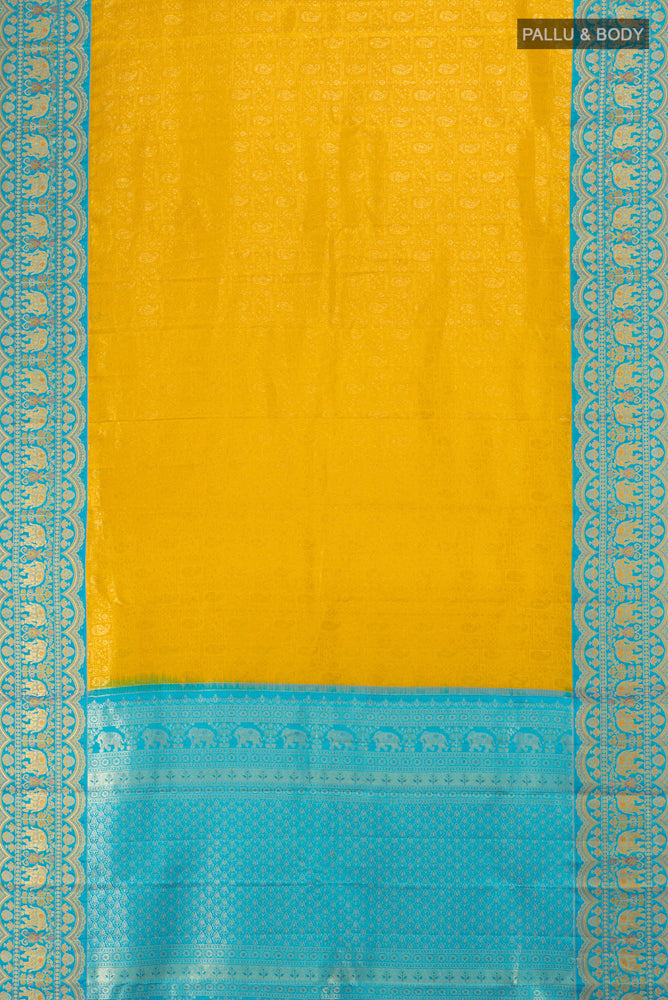 Flat view of Mustard Kanjivaram Silk Saree with Zari Butta on the body and Silk Border. 