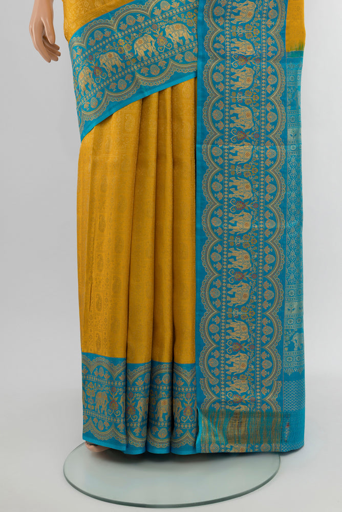 Pleats and pallu of Mustard Kanjivaram Silk Saree with Zari Butta on the body and Silk Border. 