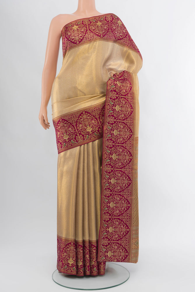Golden Kanjivaram Silk Saree with Zari Butta on the body and Silk Border.  displayed on a mannequin
