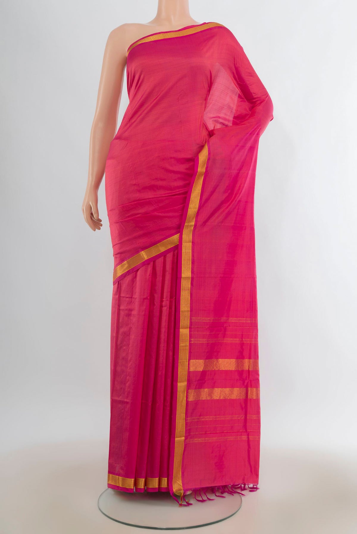 Pure Silk Pink Kanjivaram Saree with Plain Body and Zari Border.  displayed on a mannequin