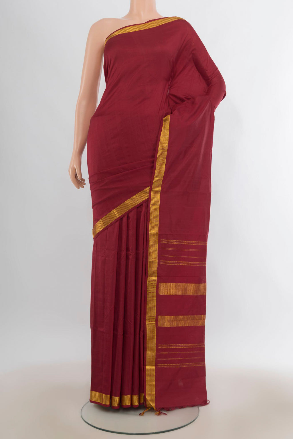 Pure Silk Maroon Kanjivaram Saree with Plain Body and Zari Border.  displayed on a mannequin