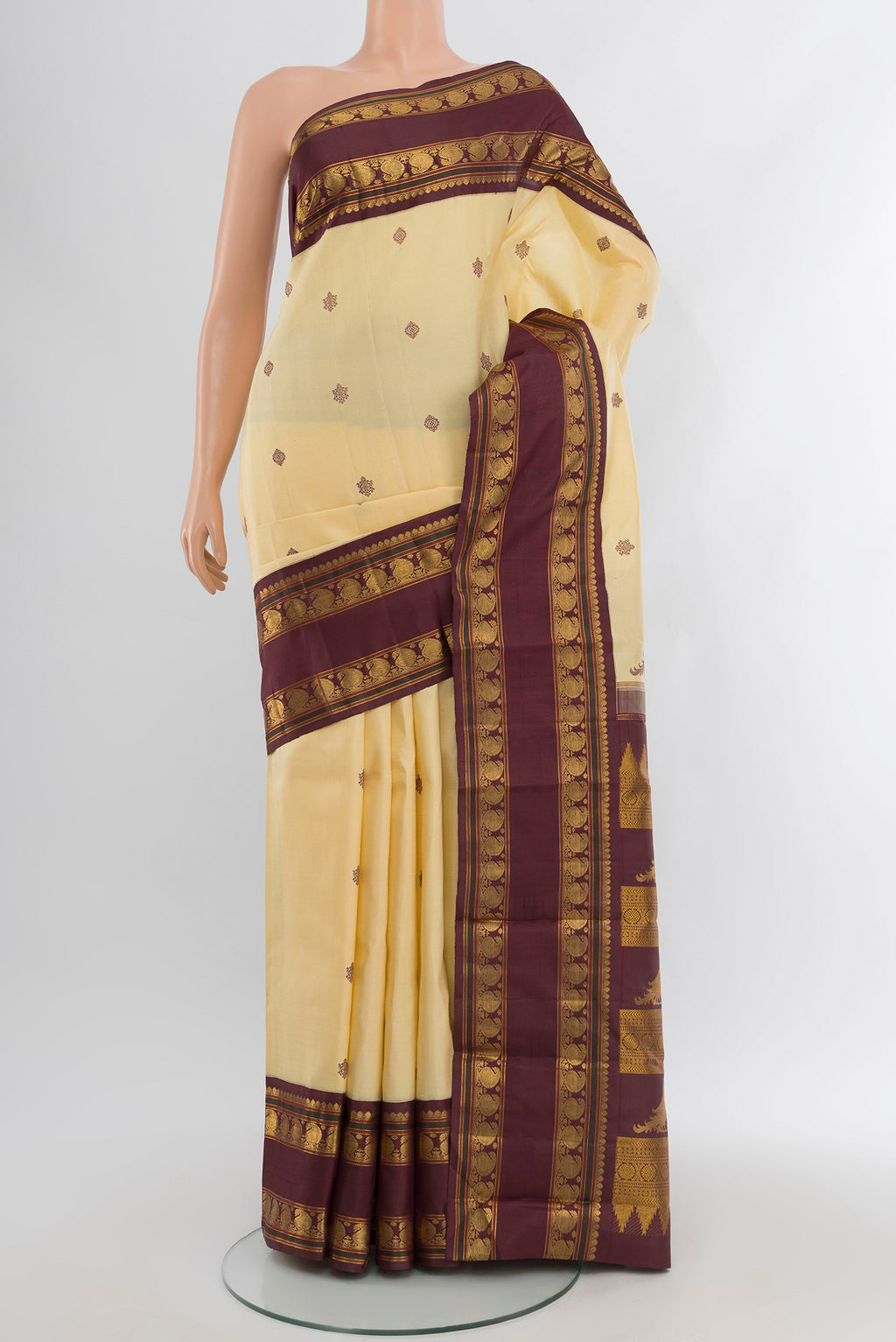 Sandal Kanchipuram Silk Saree with Thread Butta on the body and Zari Border.  displayed on a mannequin