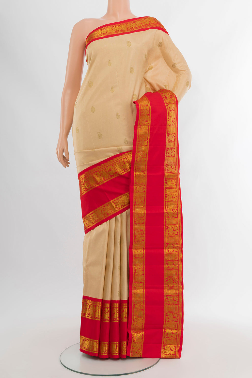 Cream Kanchipuram Silk Saree with Zari Butta on the body and Zari Border.  displayed on a mannequin