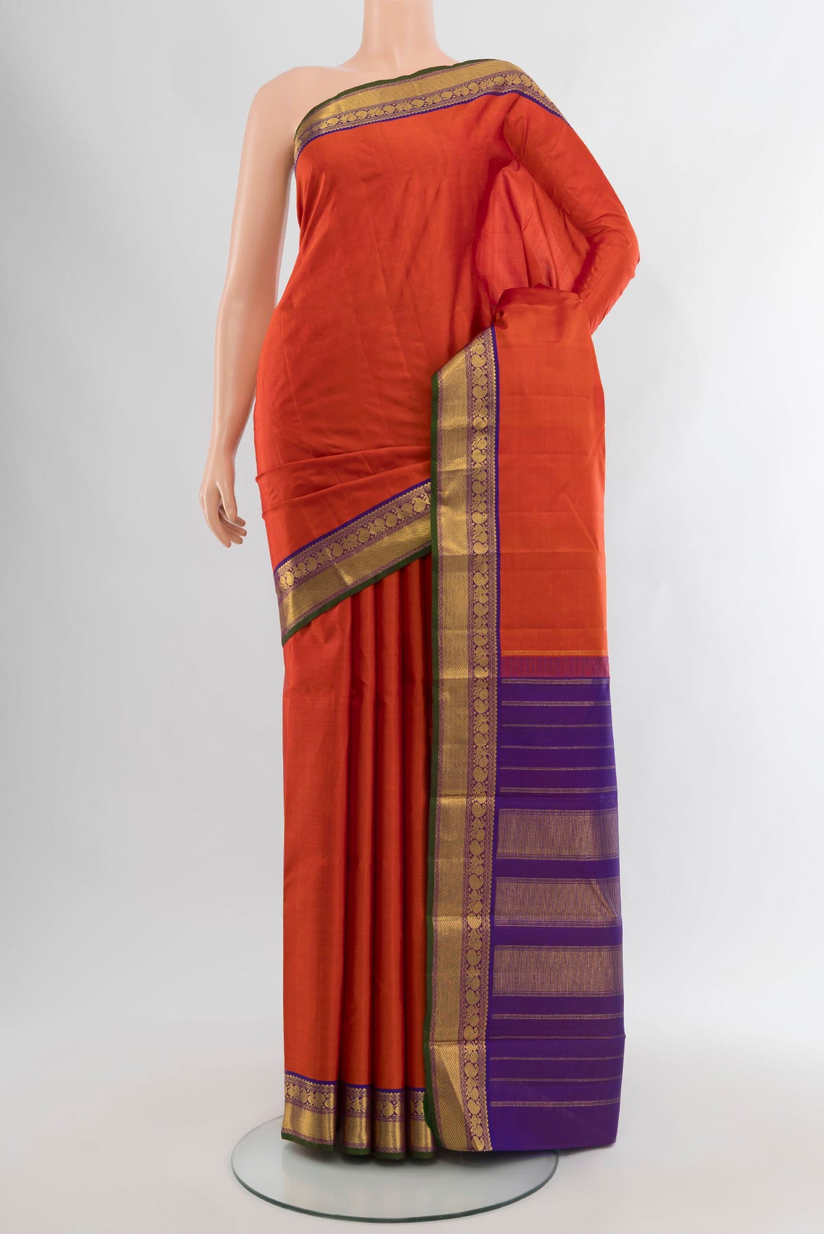 Rust Kanchipuram Silk Saree with Zari Butta on the body and Zari Border.  displayed on a mannequin