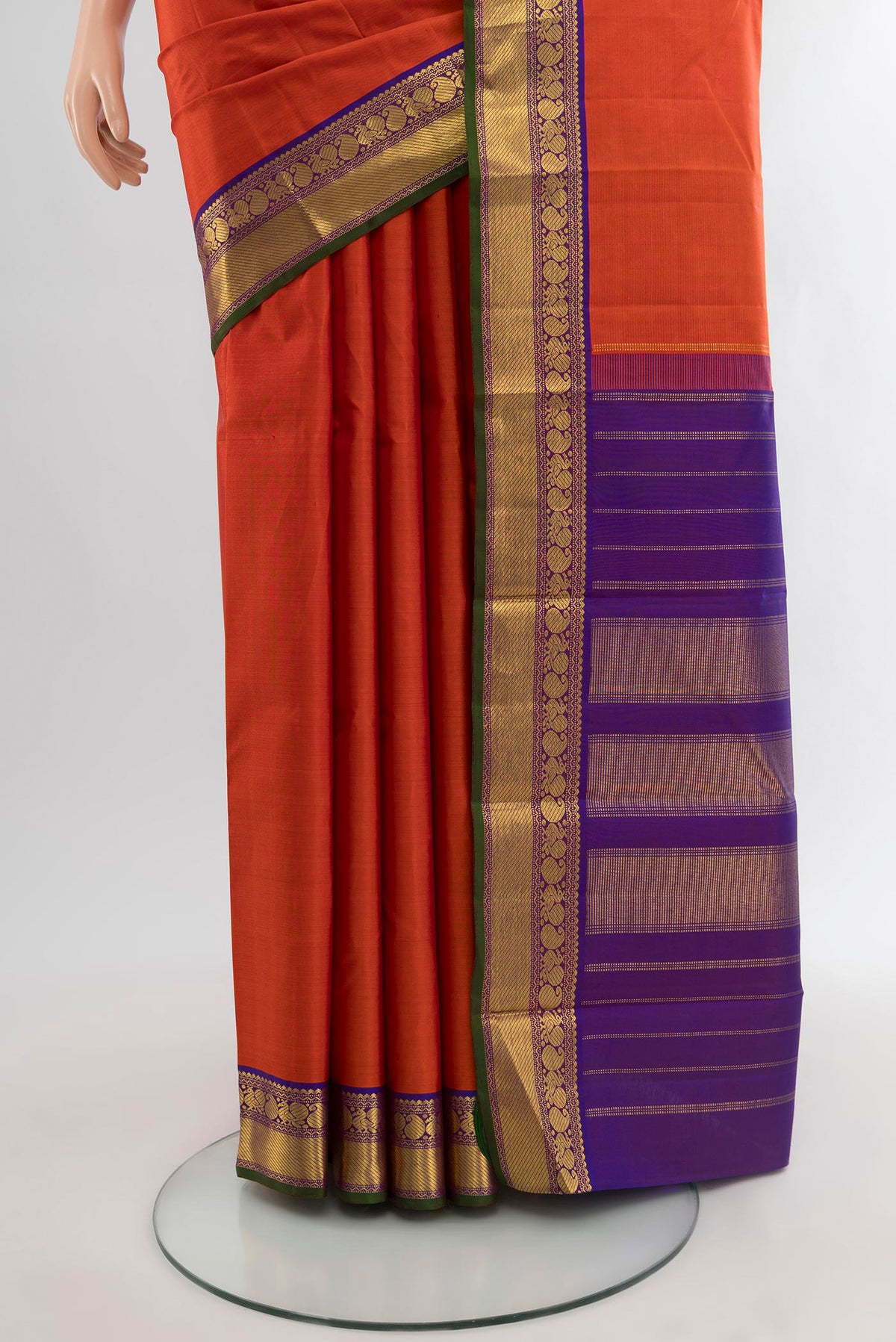 Pleats and pallu of Rust Kanchipuram Silk Saree with Zari Butta on the body and Zari Border. 