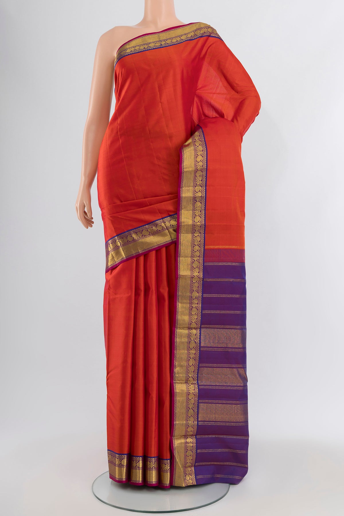 Orange Kanchipuram Silk Saree with Plain Body and Zari Border.  displayed on a mannequin