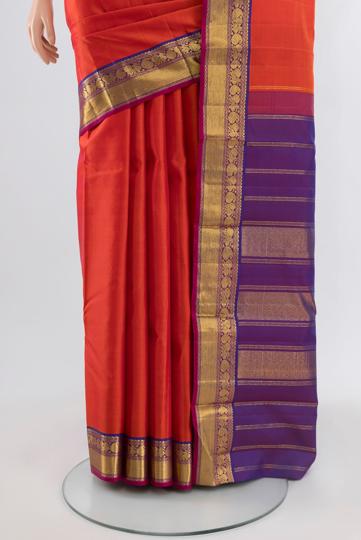 Pleats and pallu of Orange Kanchipuram Silk Saree with Plain Body and Zari Border. 