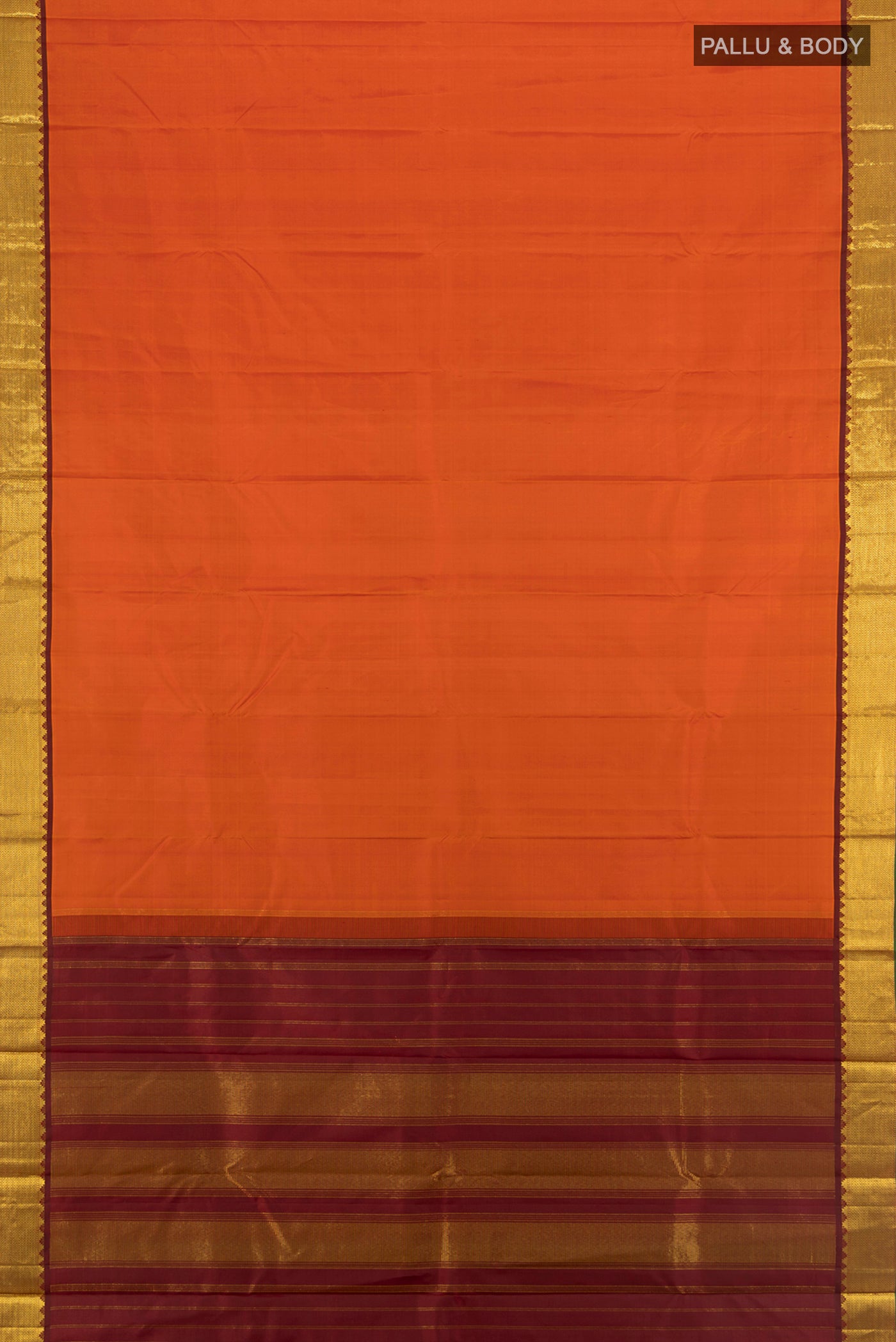 Flat view of Rust Kanchipuram Silk Saree with Plain Body and Zari Border. 