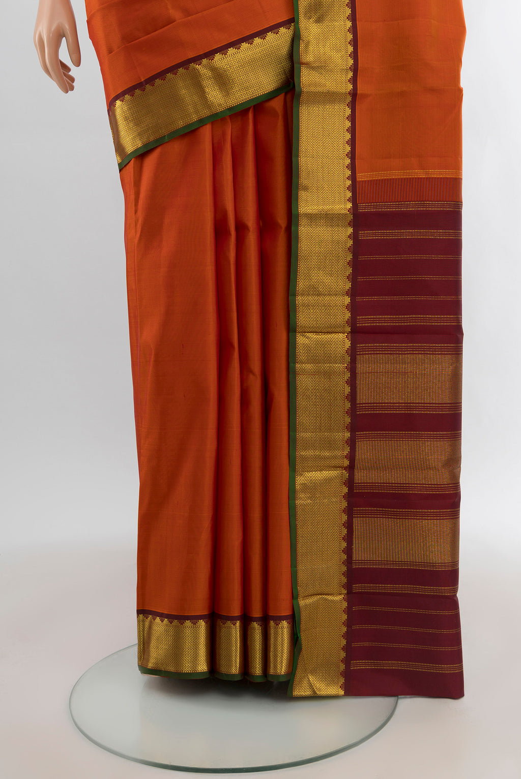 Pleats and pallu of Rust Kanchipuram Silk Saree with Plain Body and Zari Border. 