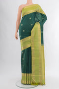 Bottle Green Kanchipuram Silk Saree with Zari Butta on the body and Zari Border.  displayed on a mannequin