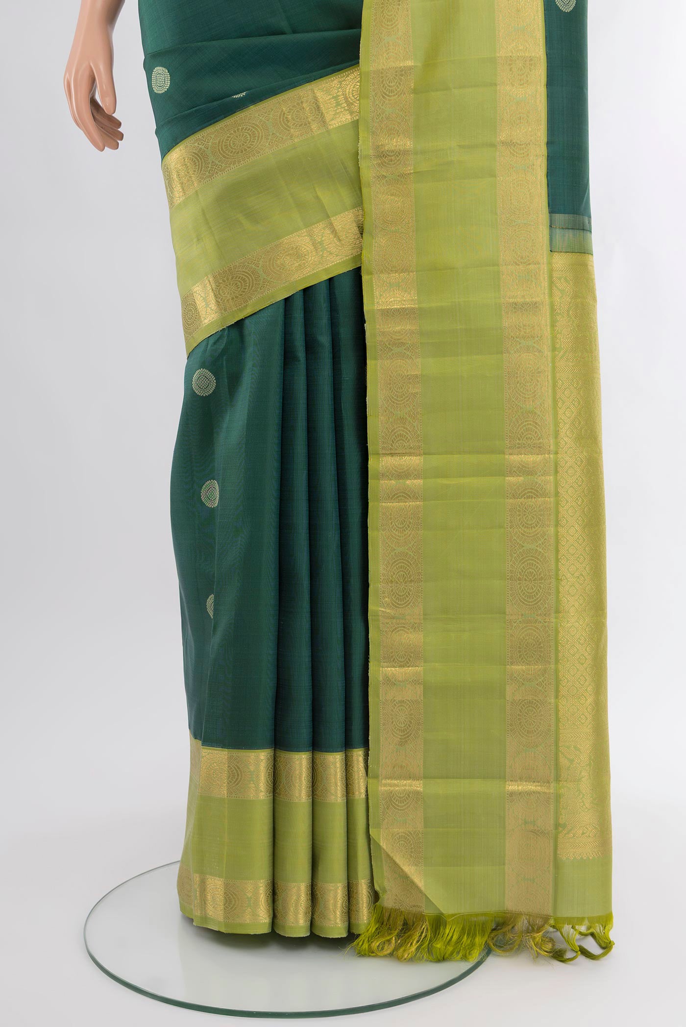 Pleats and pallu of Bottle Green Kanchipuram Silk Saree with Zari Butta on the body and Zari Border. 
