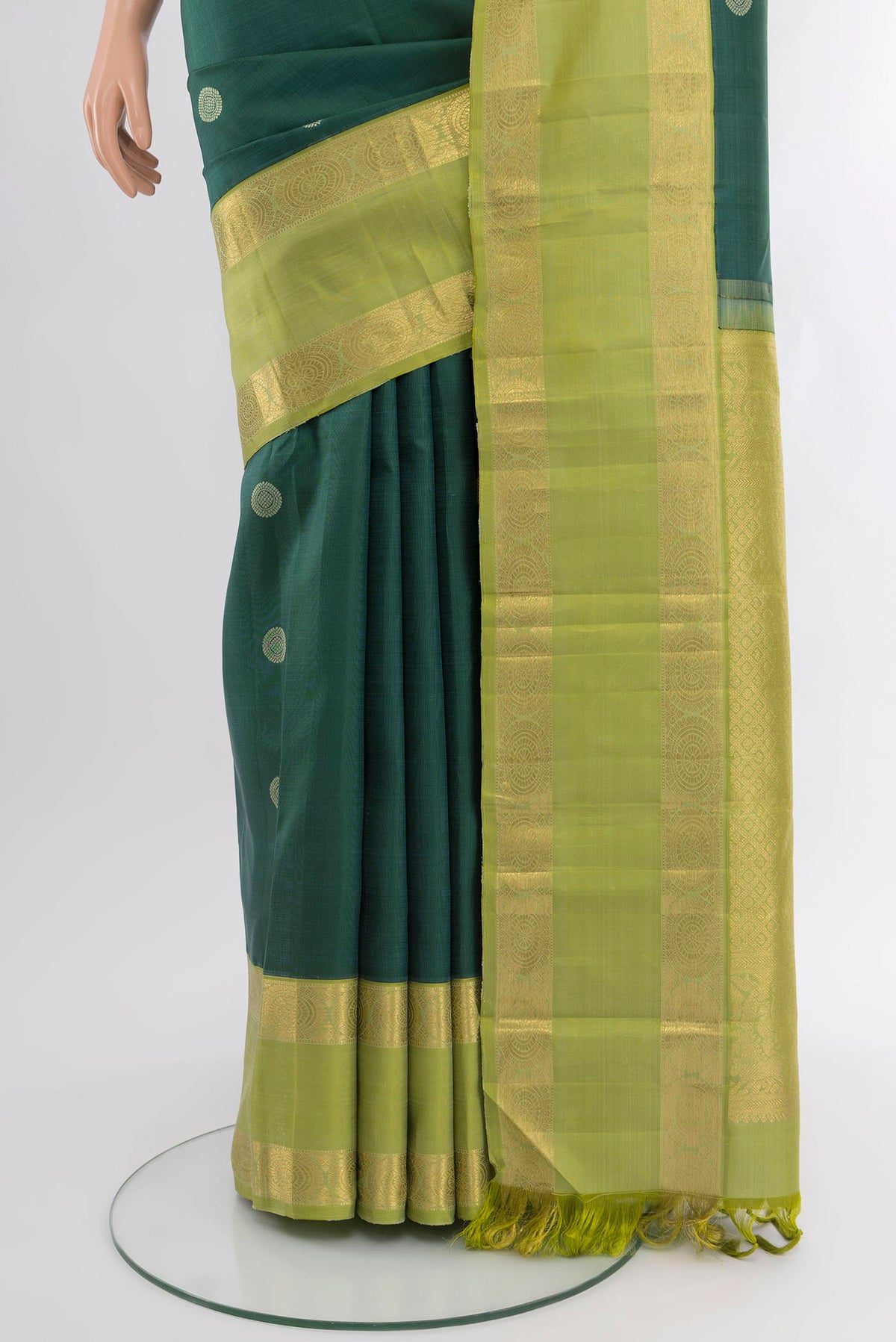 Pleats and pallu of Bottle Green Kanchipuram Silk Saree with Zari Butta on the body and Zari Border. 