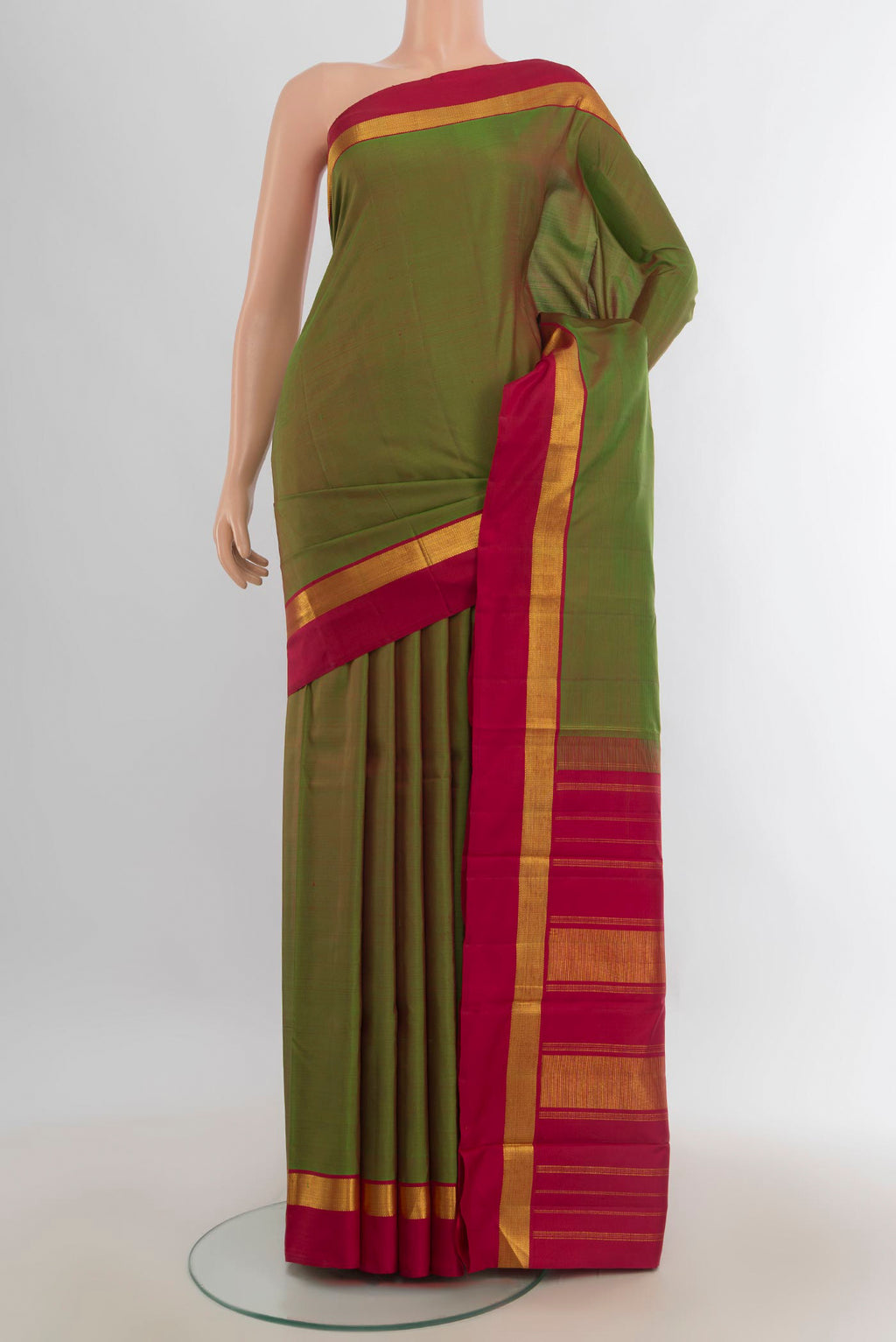 Pure Silk Mehandi Green Kanjivaram Saree with Plain Body and Silk Border.  displayed on a mannequin