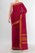 Maroon Kanchipuram Silk Saree with Stripes on the body and Zari Border.  displayed on a mannequin