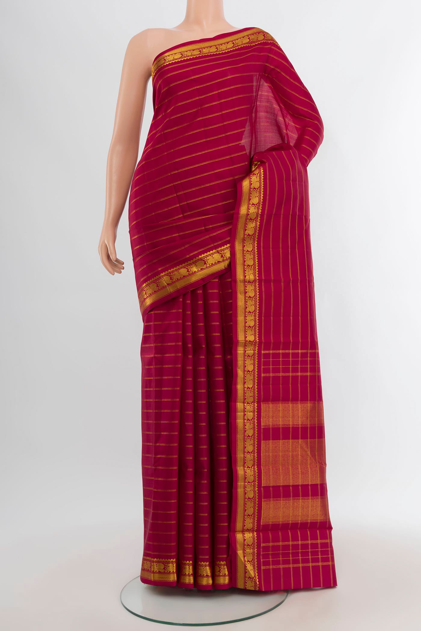 Maroon Kanchipuram Silk Saree with Stripes on the body and Zari Border.  displayed on a mannequin
