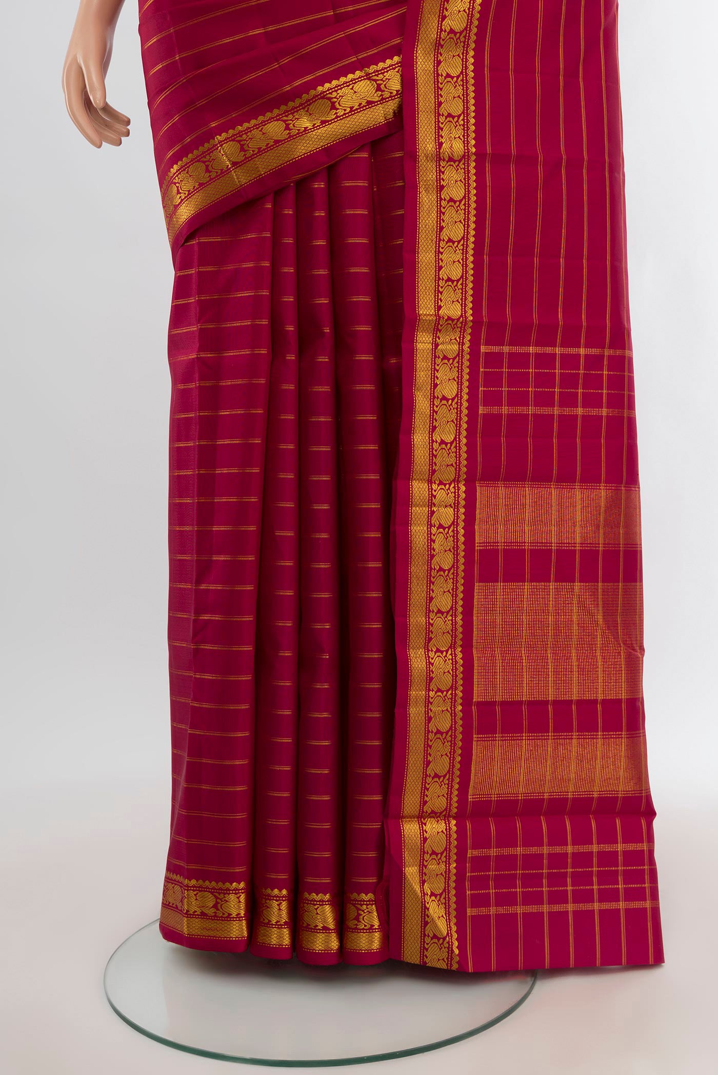 Pleats and pallu of Maroon Kanchipuram Silk Saree with Stripes on the body and Zari Border. 