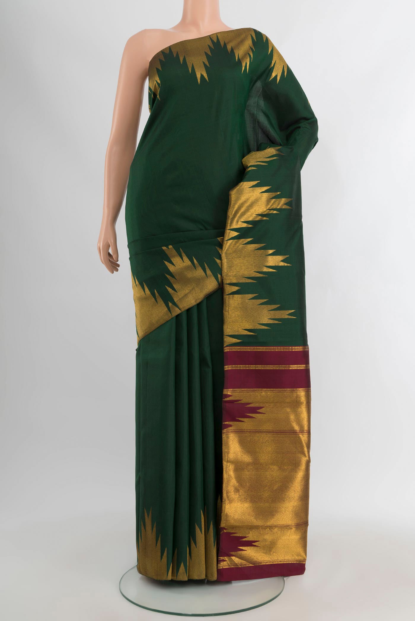Bottle Green Kanjivaram Silk Saree with Plain Body and Temple Border.  displayed on a mannequin