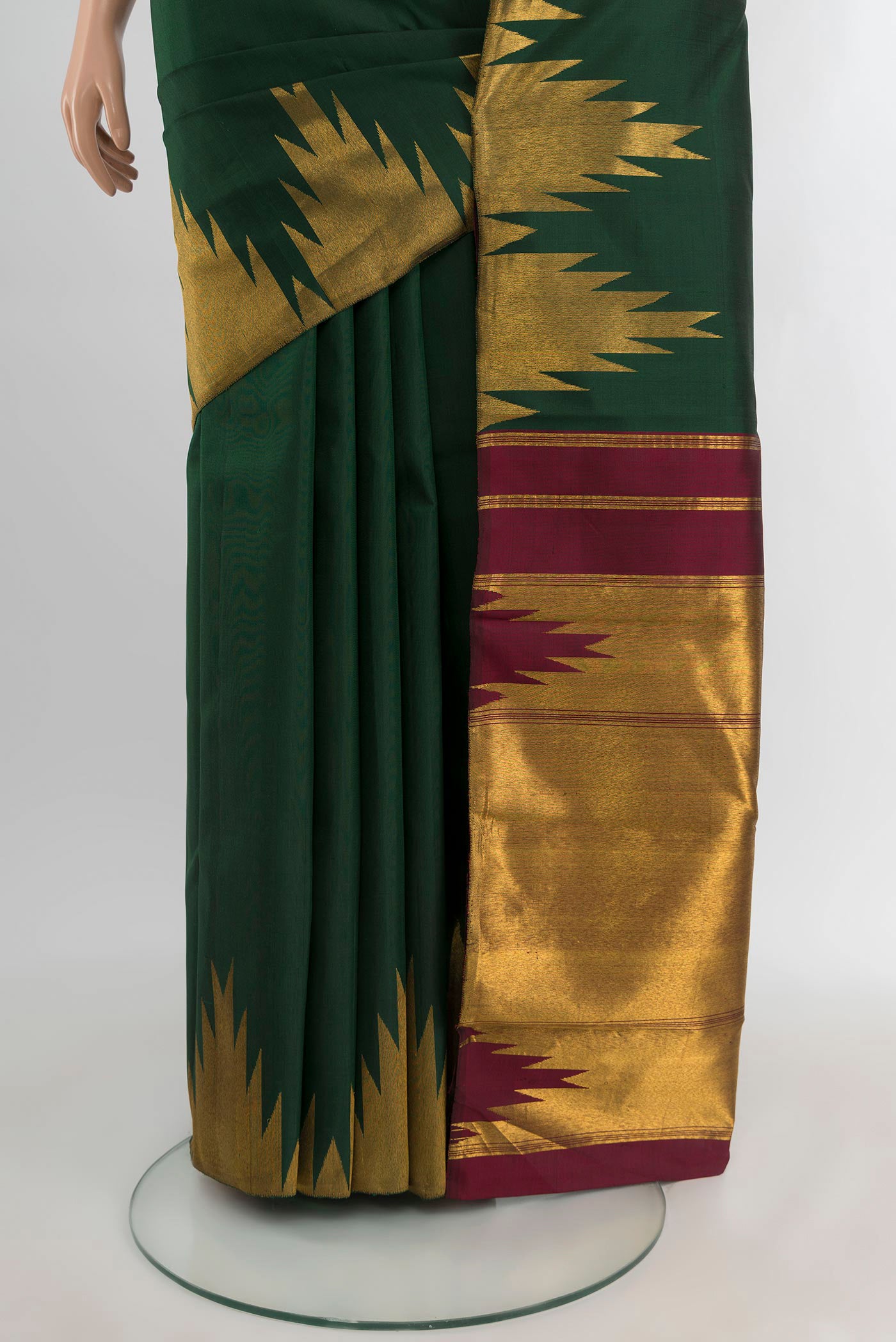 Pleats and pallu of Bottle Green Kanjivaram Silk Saree with Plain Body and Temple Border. 