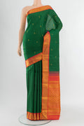 Green Kanjivaram Silk Saree with Zari Butta on the body and Zari Border.  displayed on a mannequin