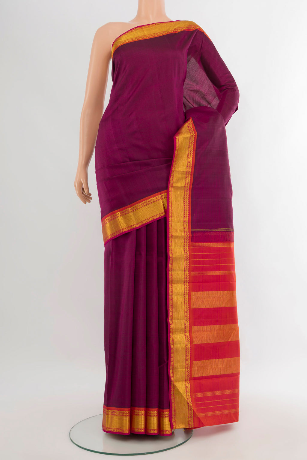 Purple Kanchipuram Silk Saree with Plain Body and Zari Border.  displayed on a mannequin