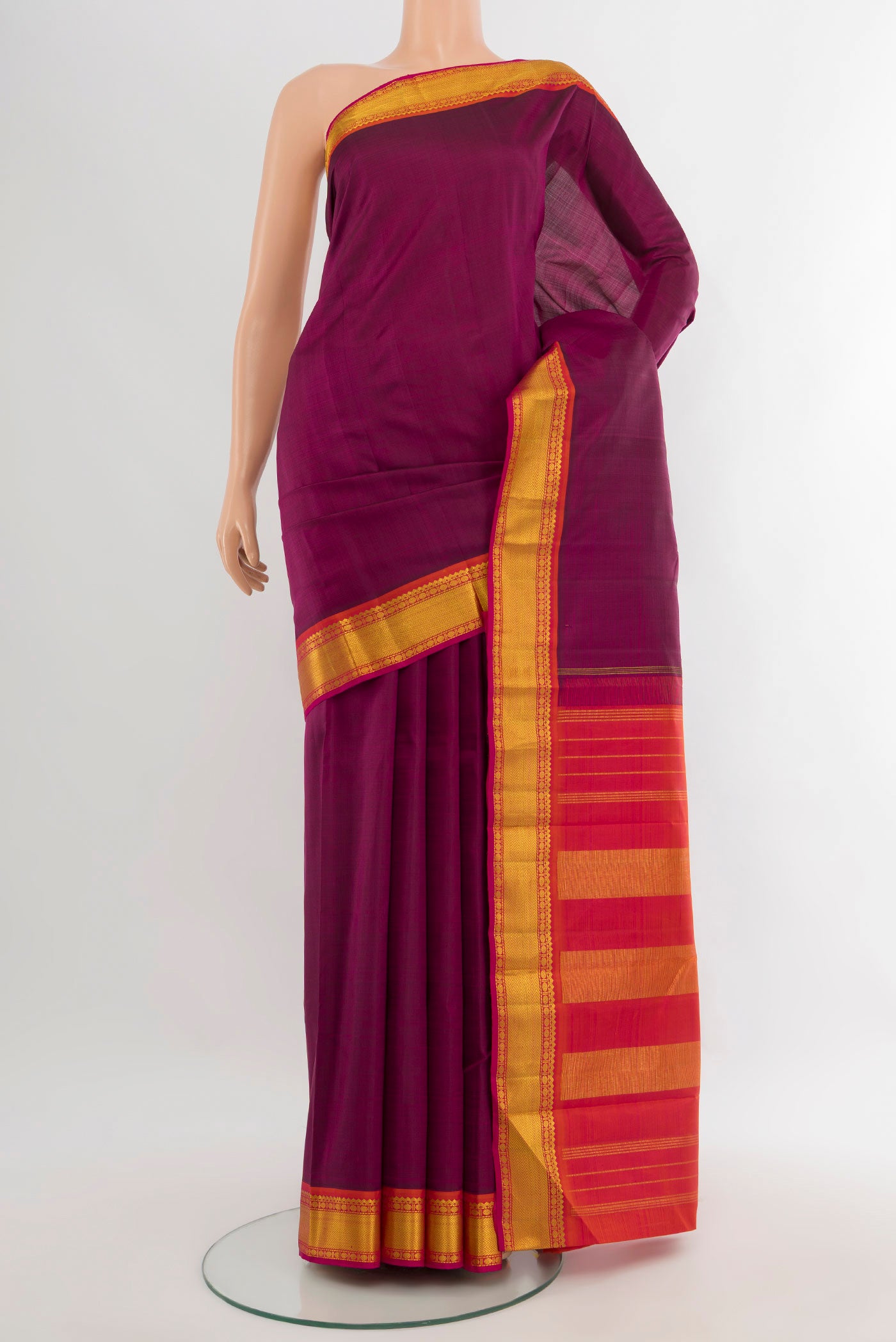 Purple Kanchipuram Silk Saree with Plain Body and Zari Border.  displayed on a mannequin