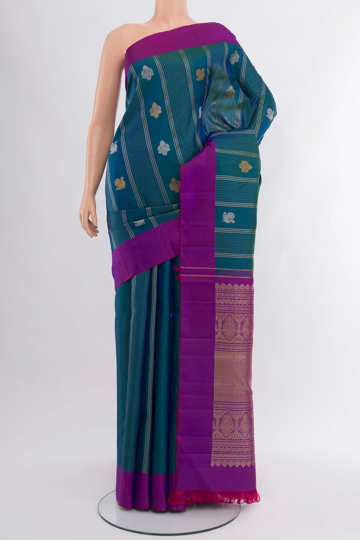 Peacock Blue Kanjivaram Silk Saree with Zari Butta on the body and Plain Border.  displayed on a mannequin