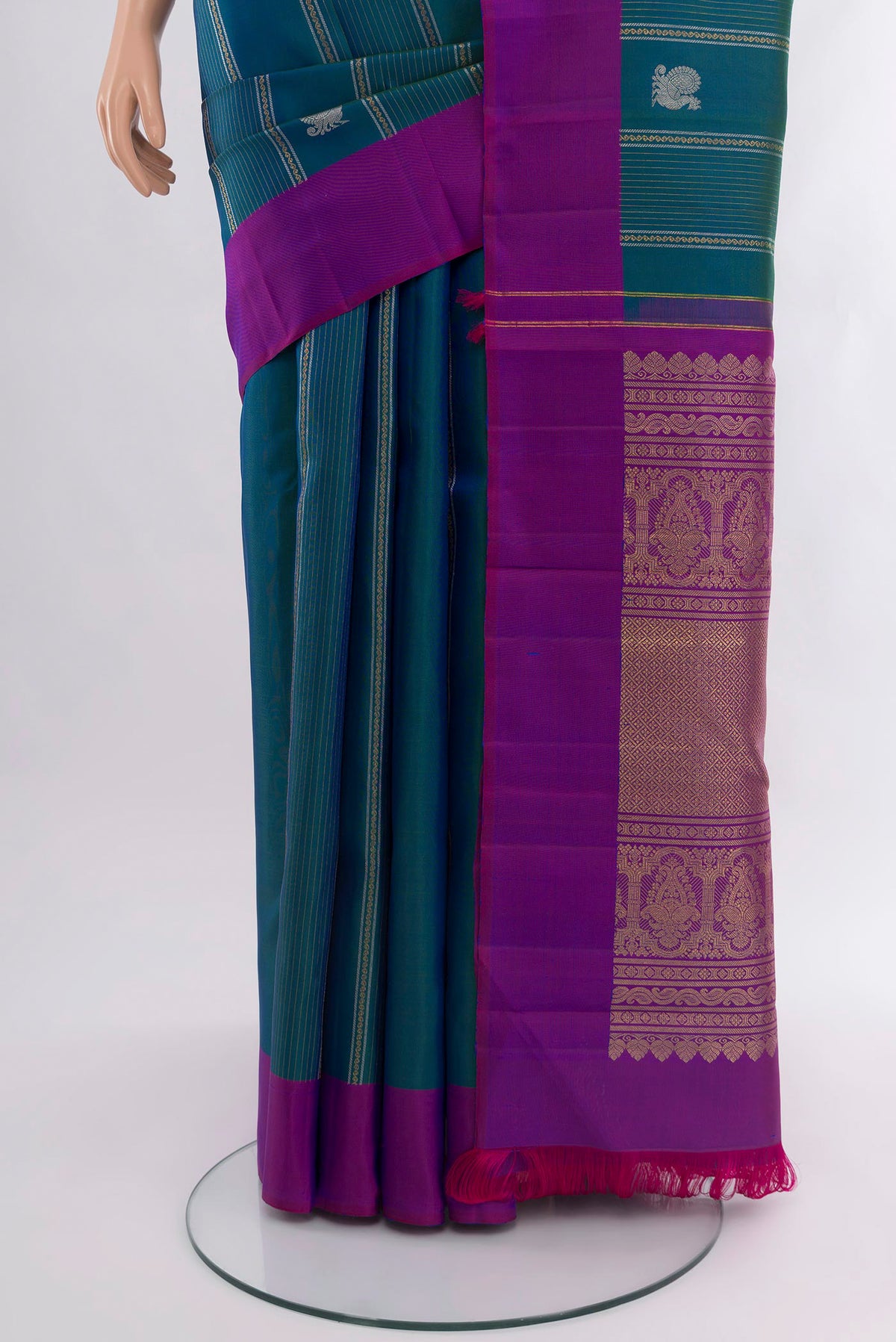 Pleats and pallu of Peacock Blue Kanjivaram Silk Saree with Zari Butta on the body and Plain Border. 