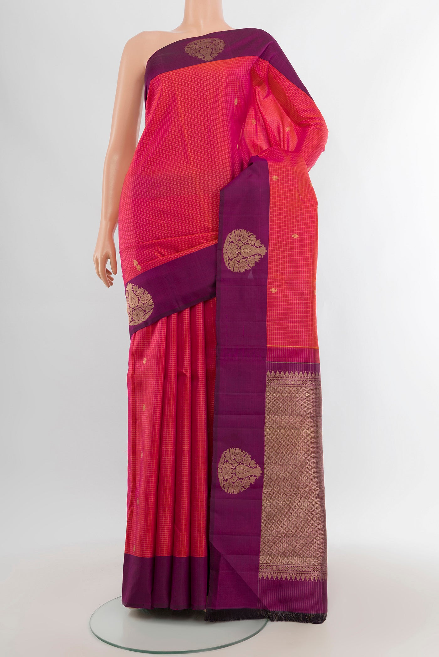 Coral Dual Tone Kanjivaram Silk Saree with Checked design on the body and Plain Border.  displayed on a mannequin