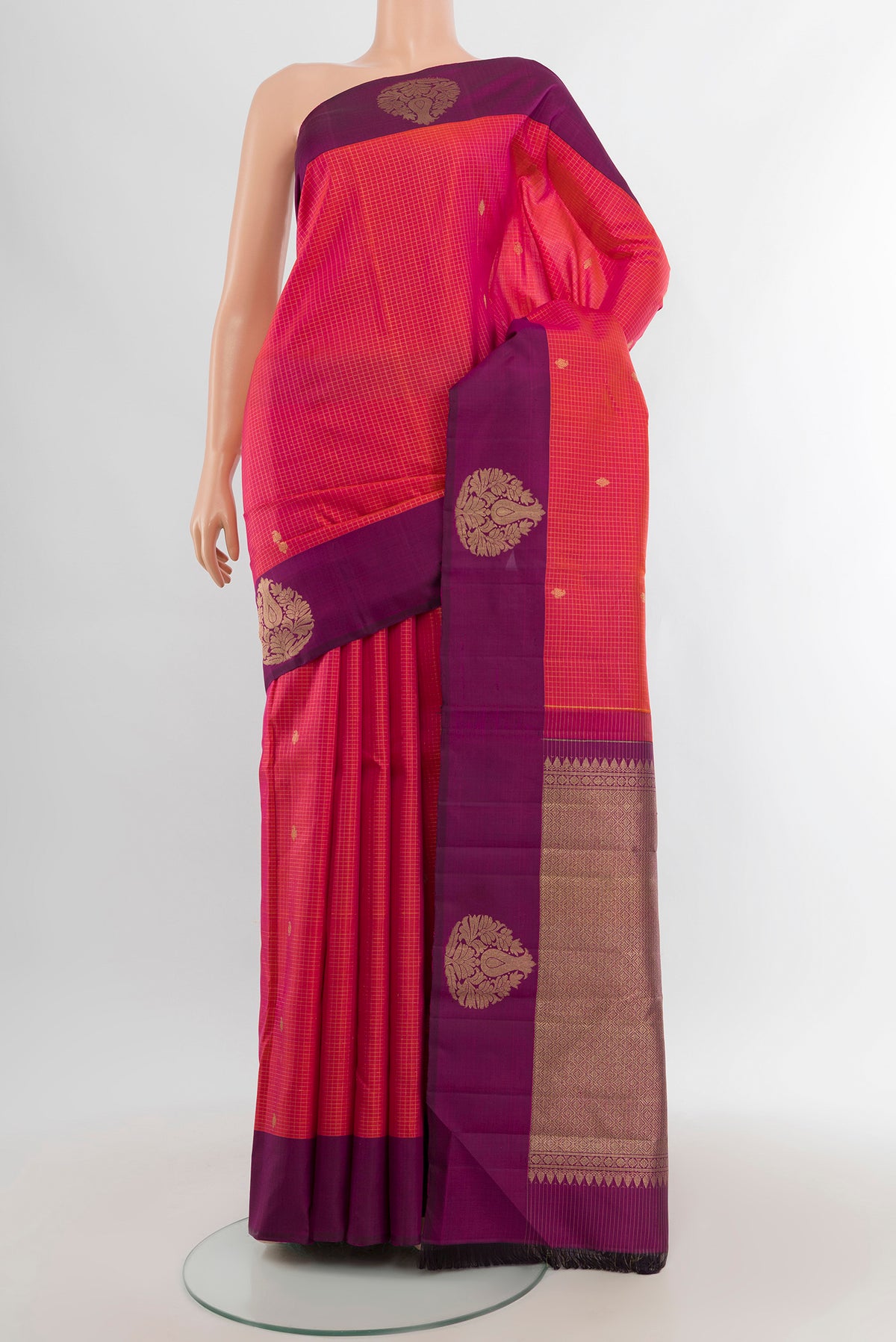Coral Dual Tone Kanjivaram Silk Saree with Checked design on the body and Plain Border.  displayed on a mannequin